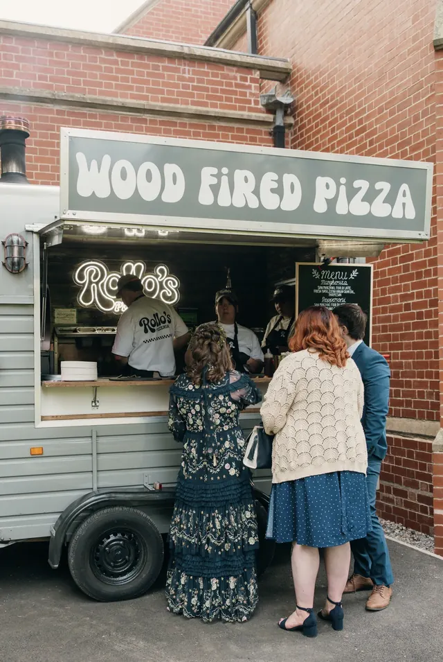Wedding guests queuing at the Rollo's horsebox